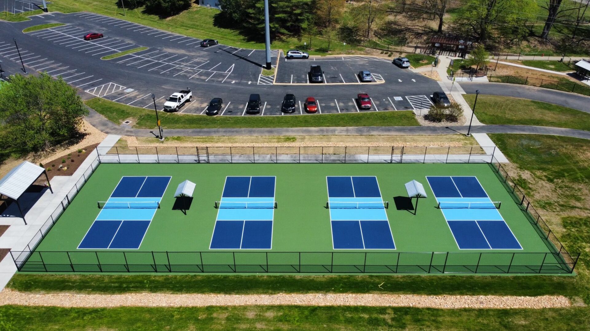 A tennis court with many blue and white tennis courts.